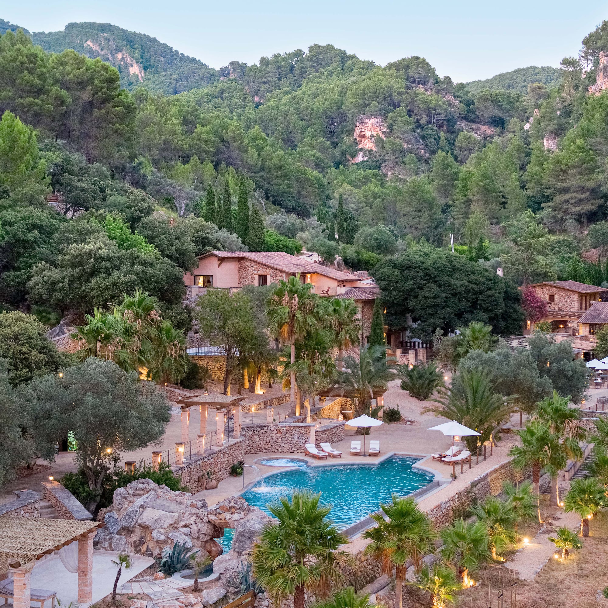 a pool surrounded by trees and buildings