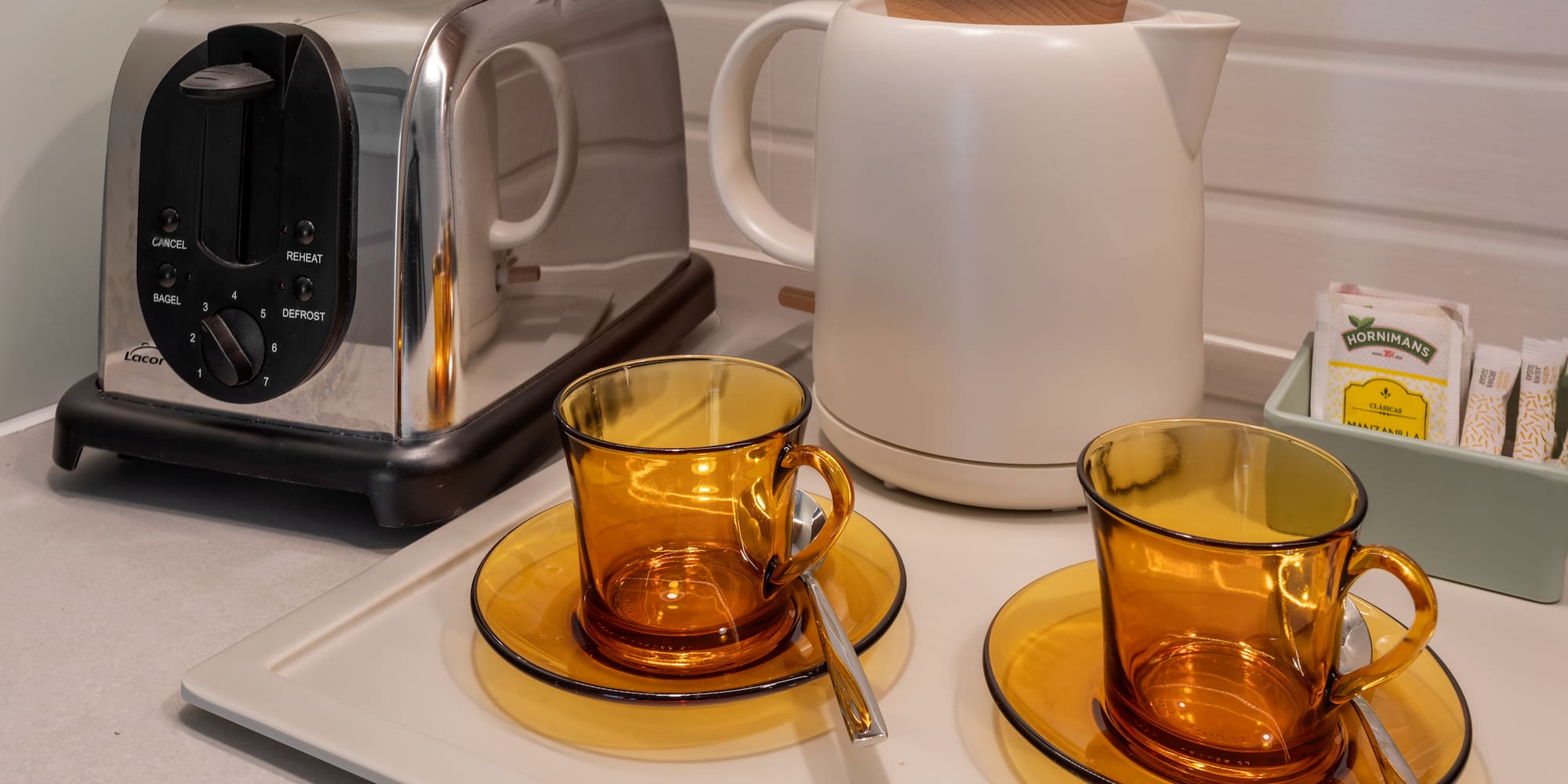 a toaster and tea set on a counter