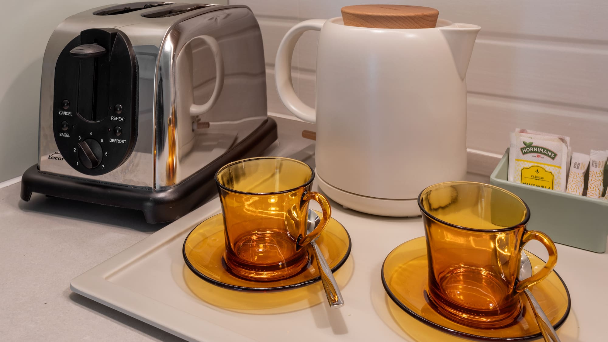 a toaster and tea set on a counter