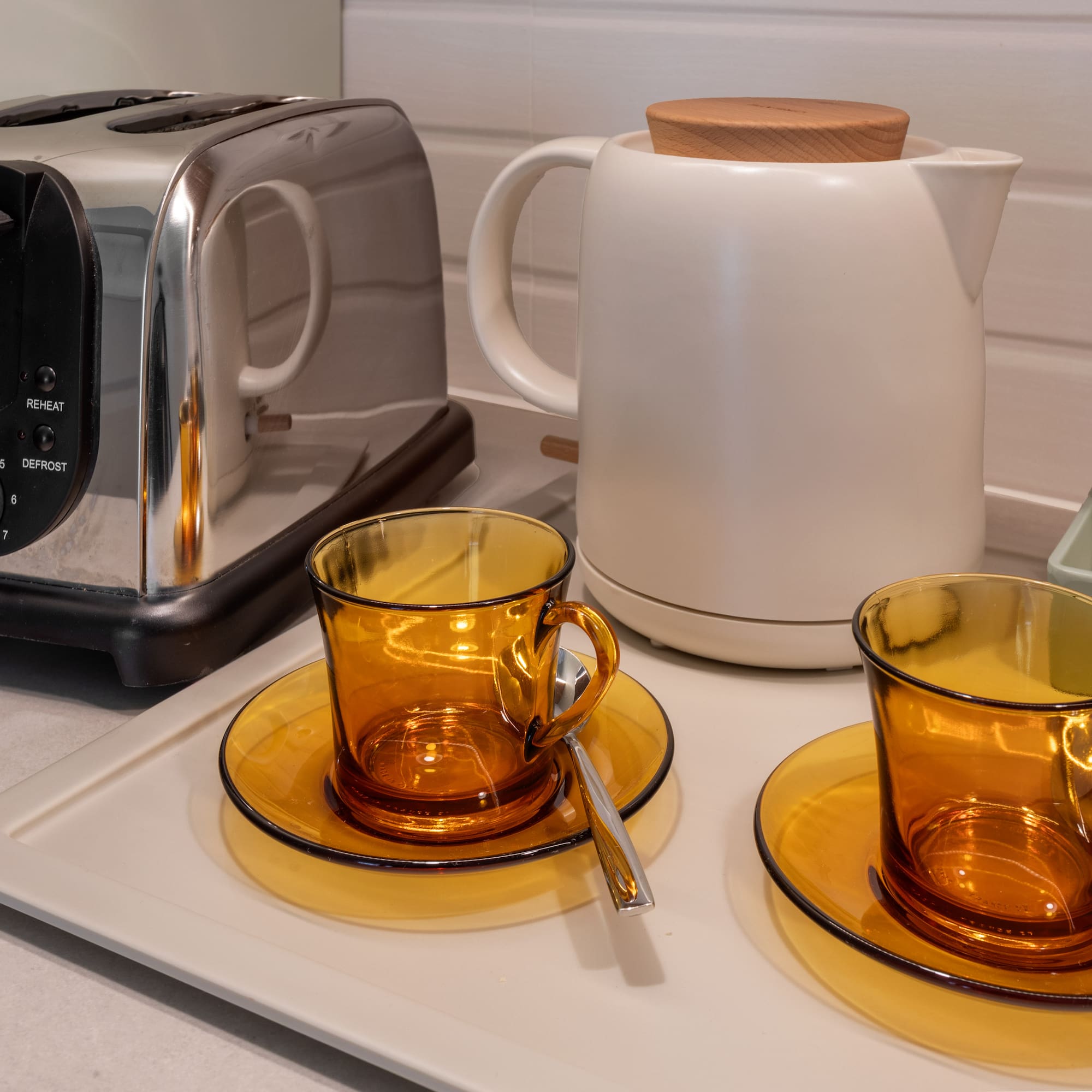 a toaster and tea set on a counter
