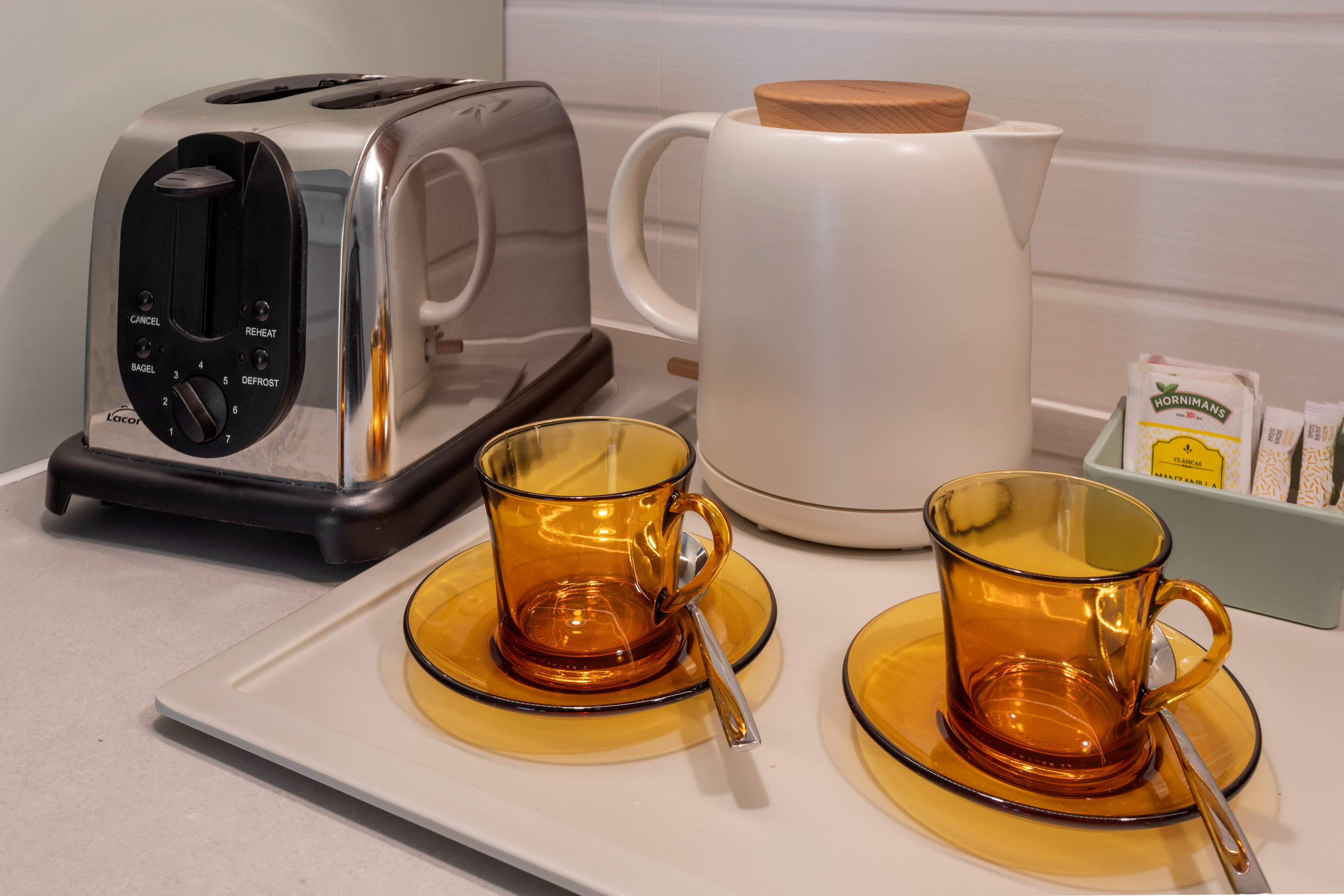a toaster and tea set on a counter
