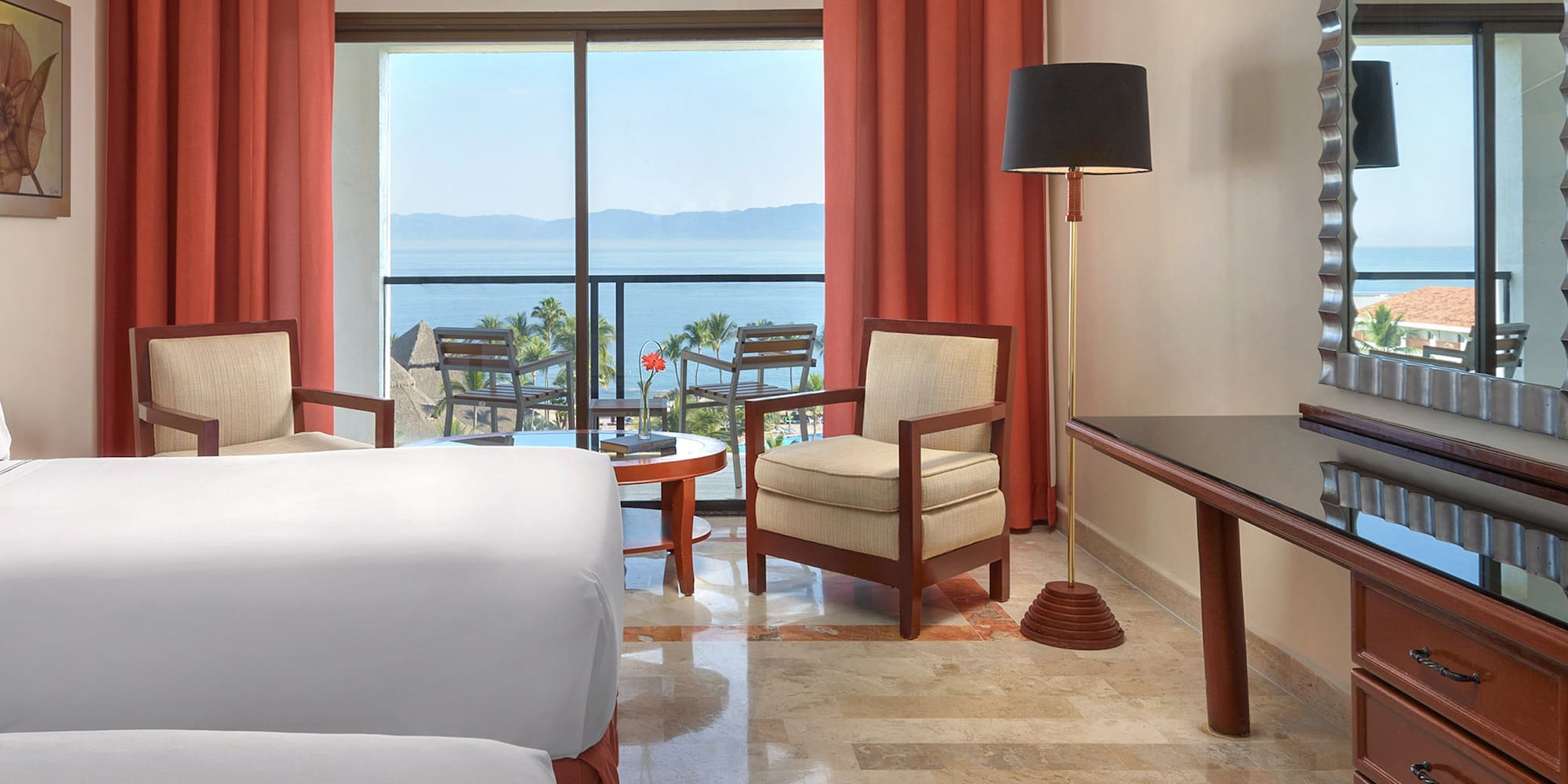 a room with a bed and a table and chairs