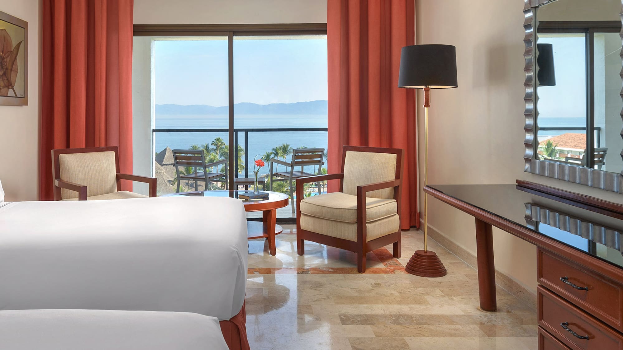 a room with a bed and a table and chairs