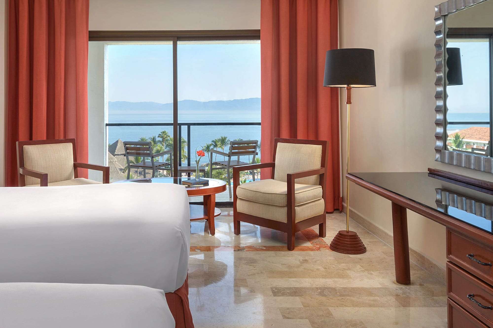 a room with a bed and a table and chairs