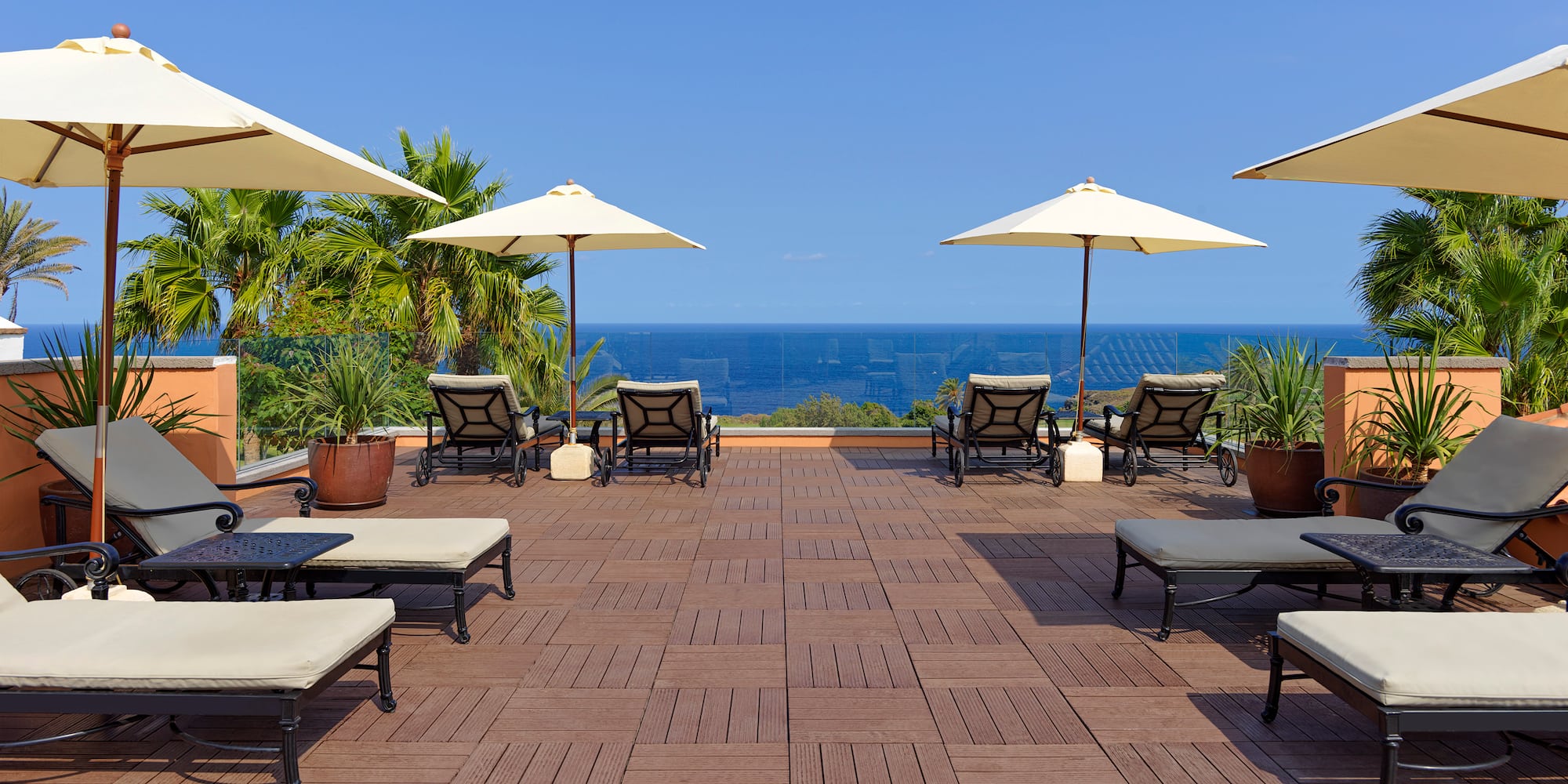 a deck with chairs and umbrellas