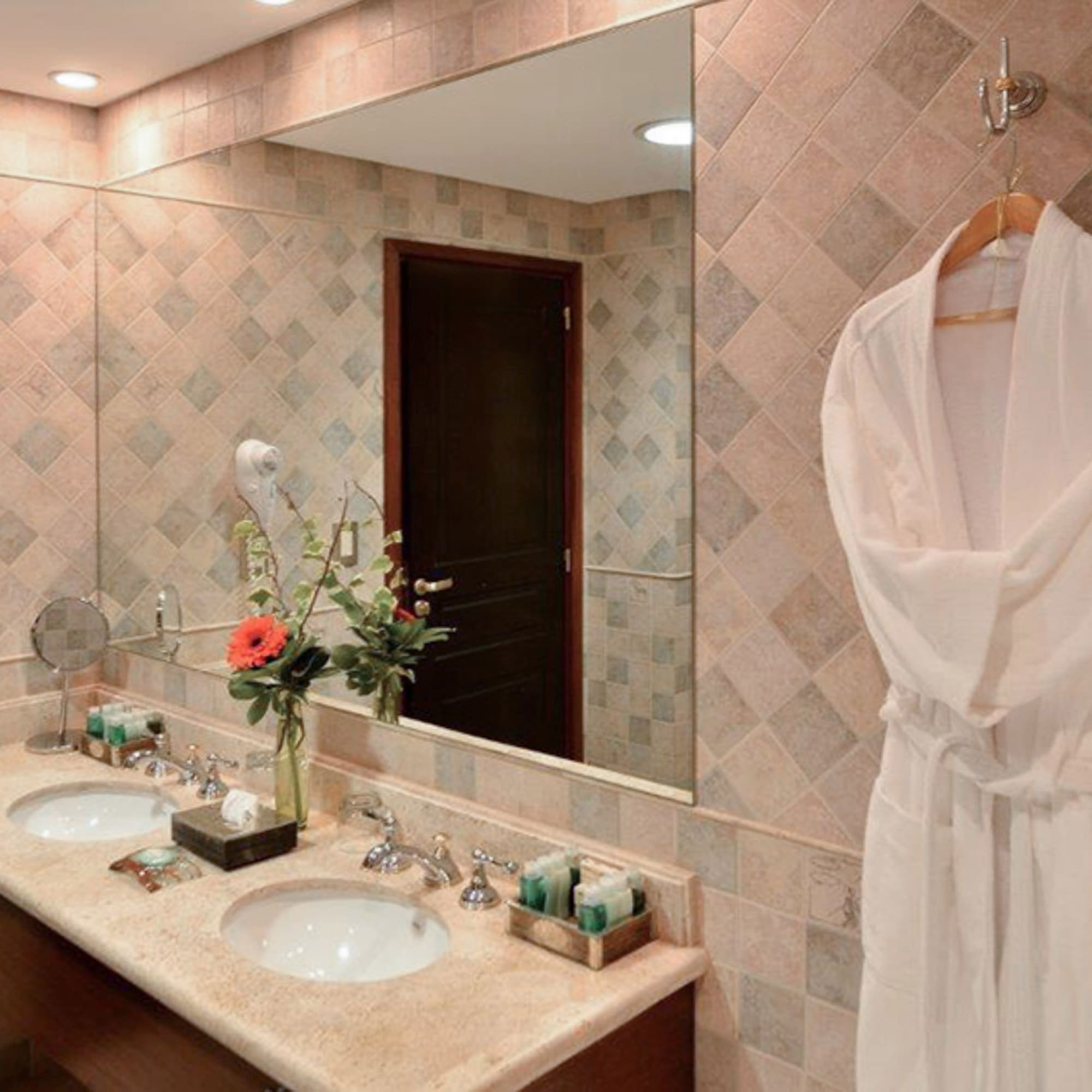 a bathroom with a white robe and a mirror