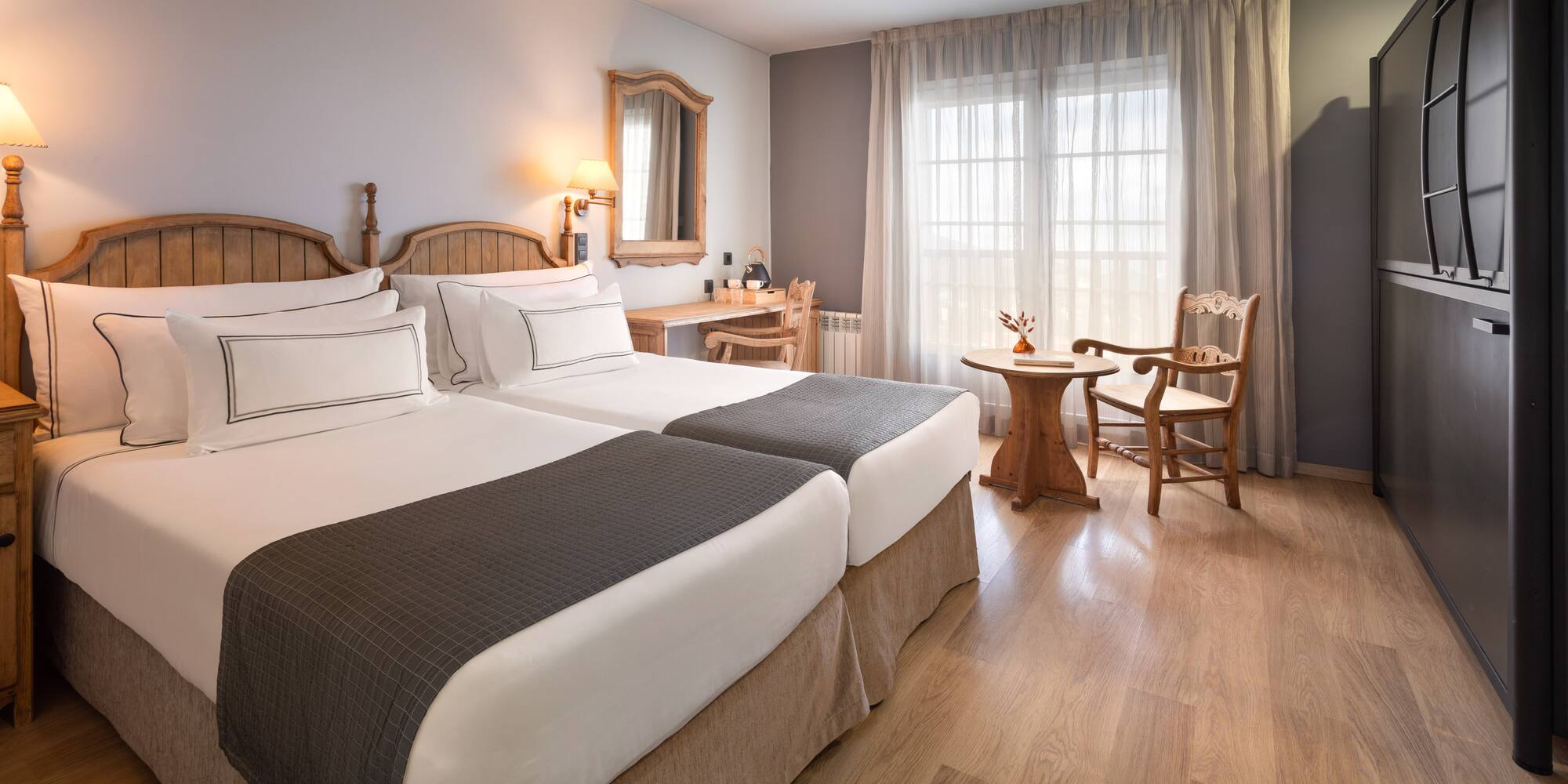 a room with two beds and a table