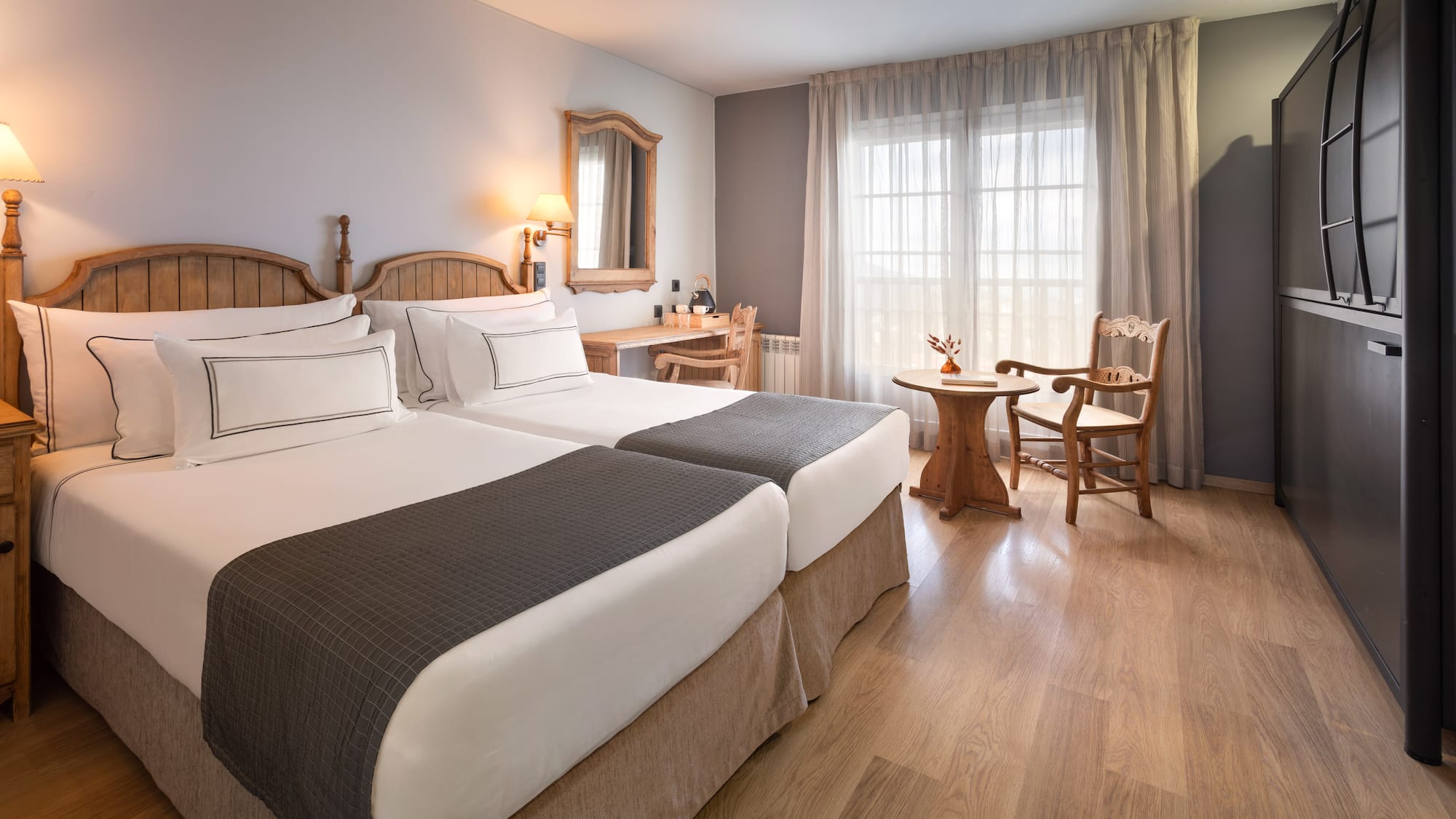 a room with two beds and a table