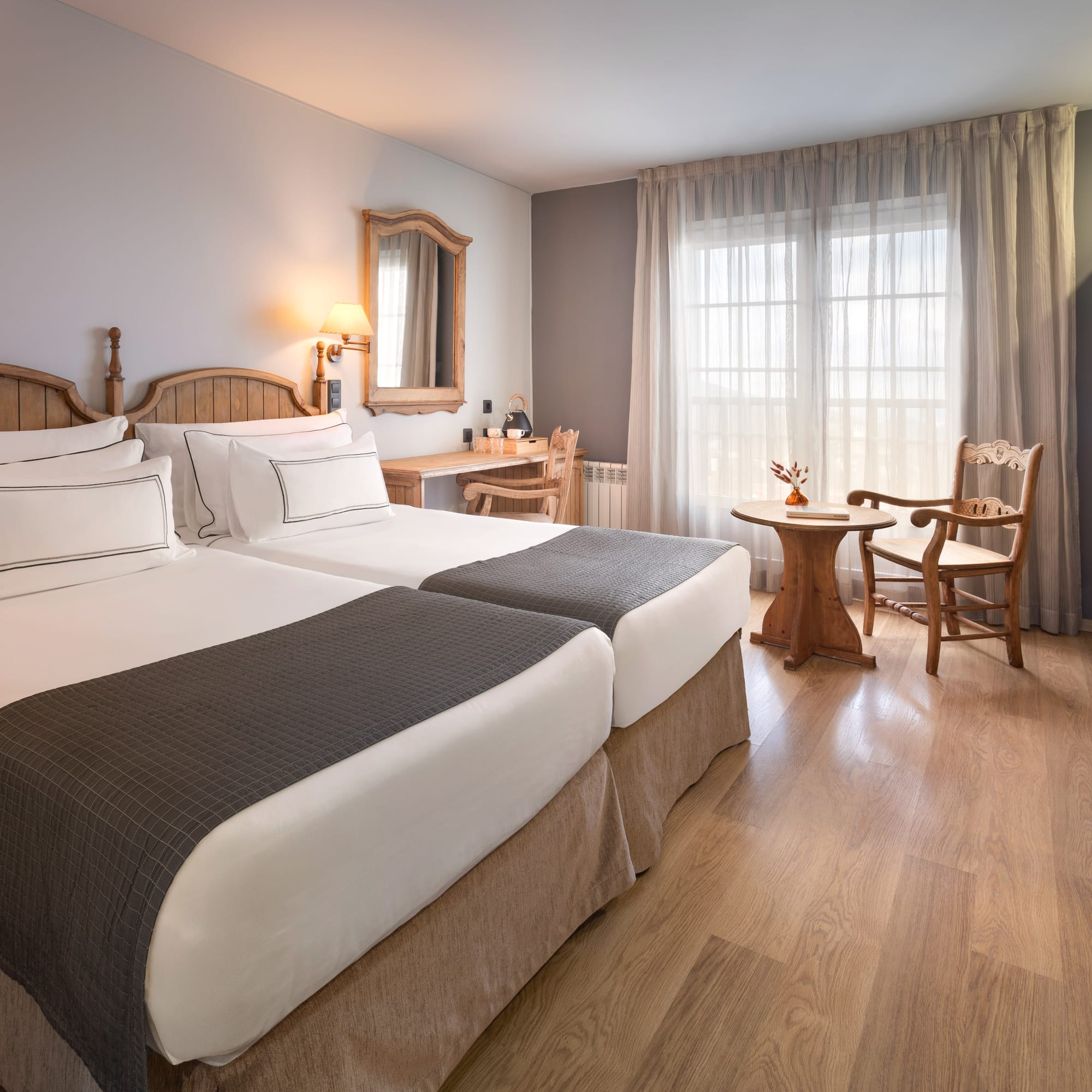 a room with two beds and a table