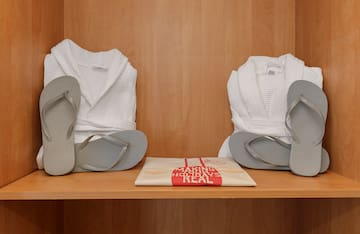 a pair of white robes and flip flops on a shelf