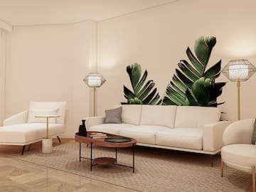 a living room with white couches and a coffee table