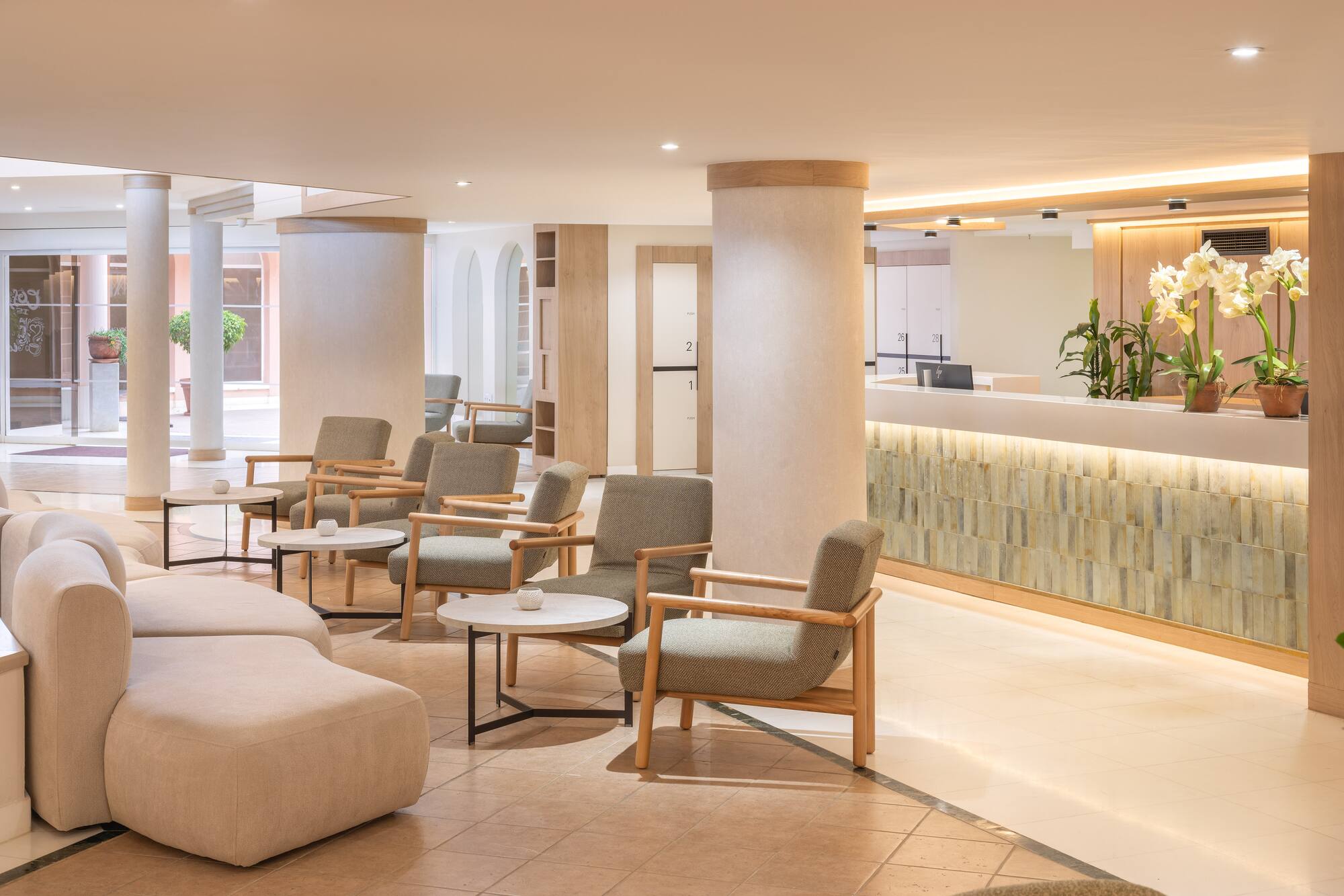 Modern hotel lobby with comfortable lounge seating and a welcoming reception desk.