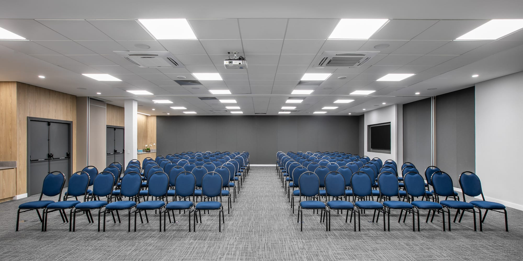 a room with rows of blue chairs