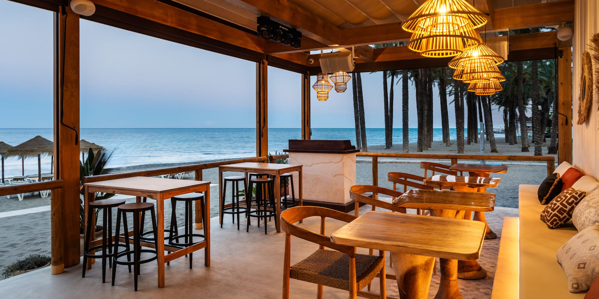 a restaurant with a thatched roof and tables and chairs