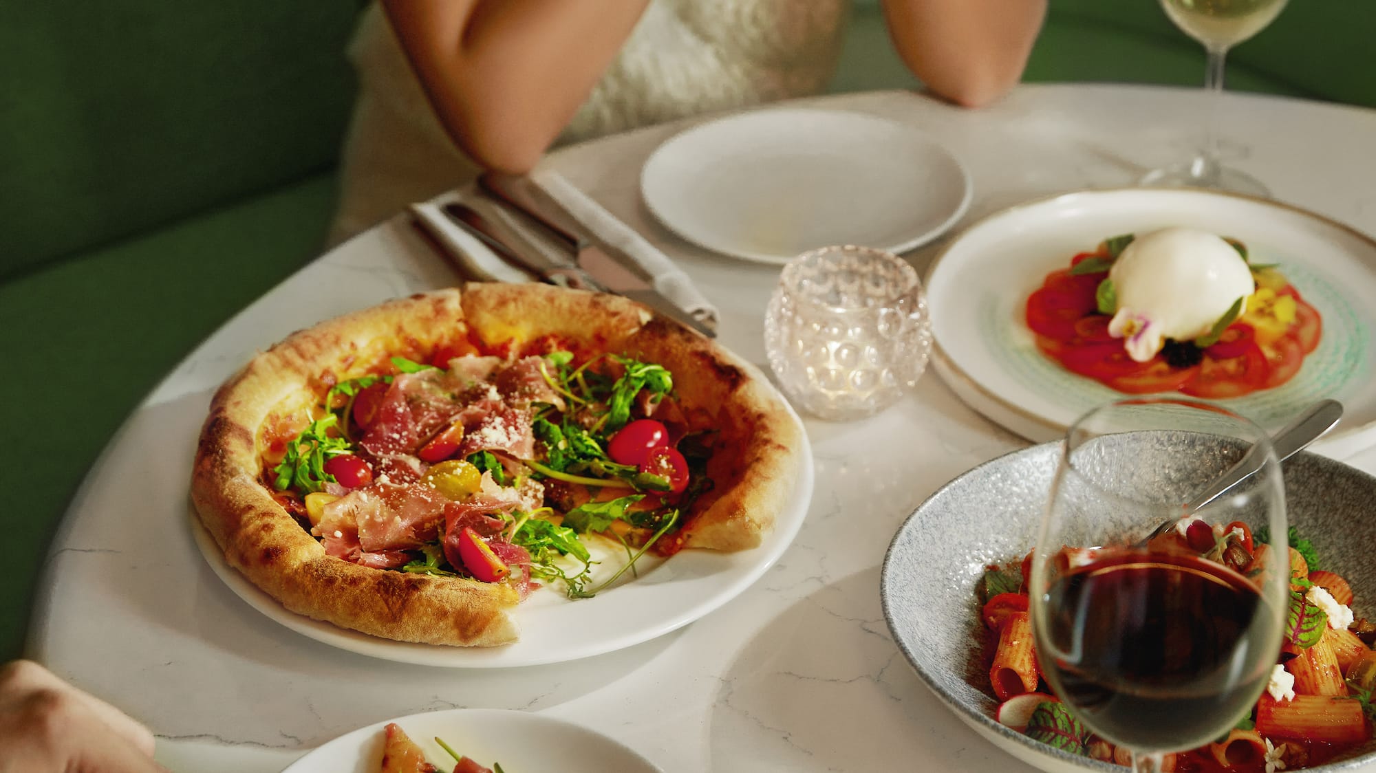 a group of people eating at a table with food