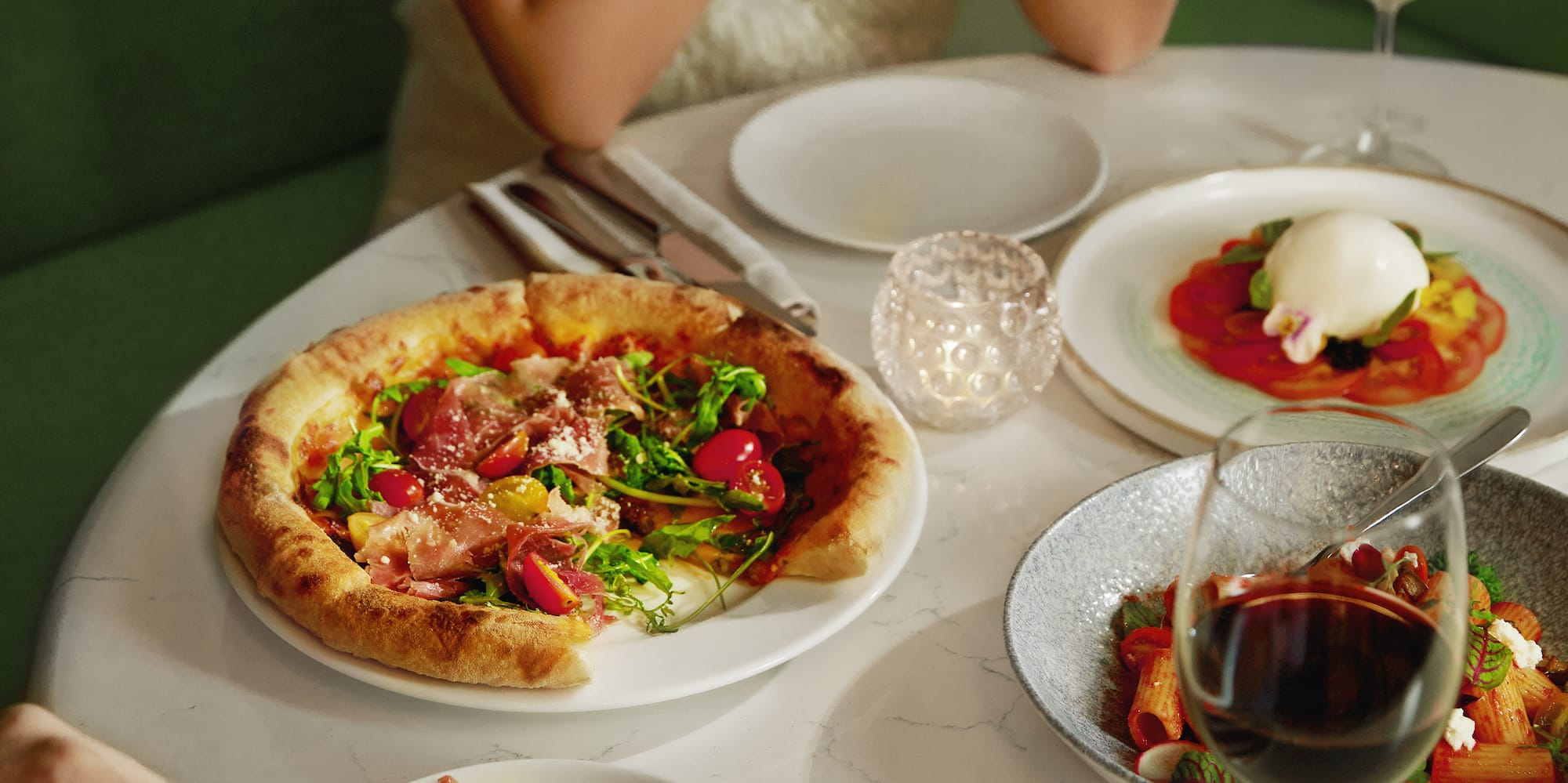 a group of people eating at a table with food