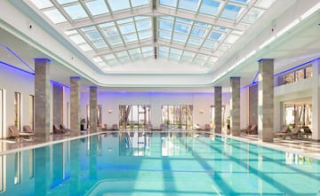 a indoor pool with a large roof