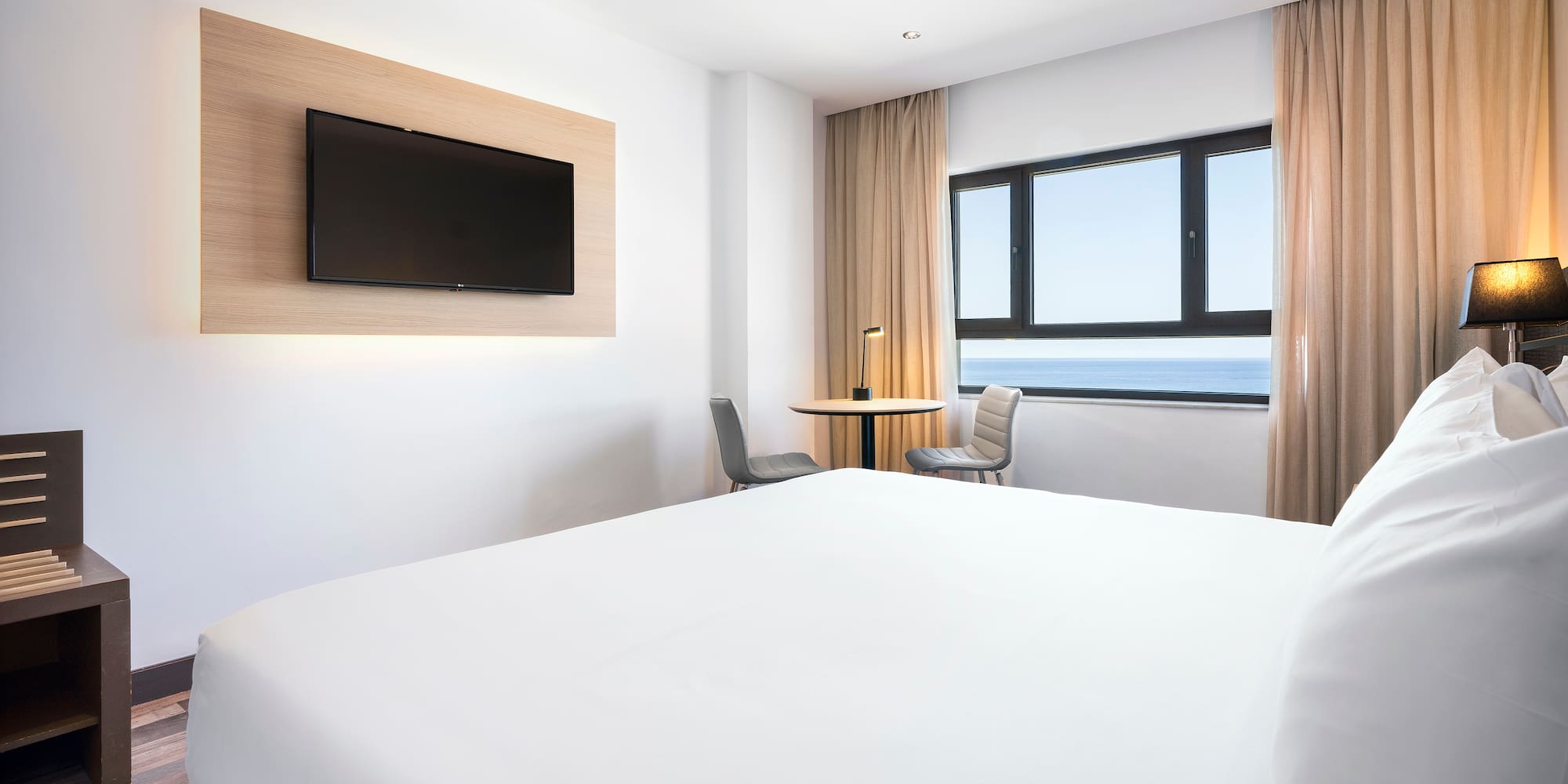 a room with a bed and a television