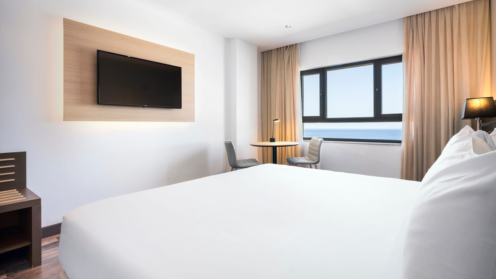 a room with a bed and a television