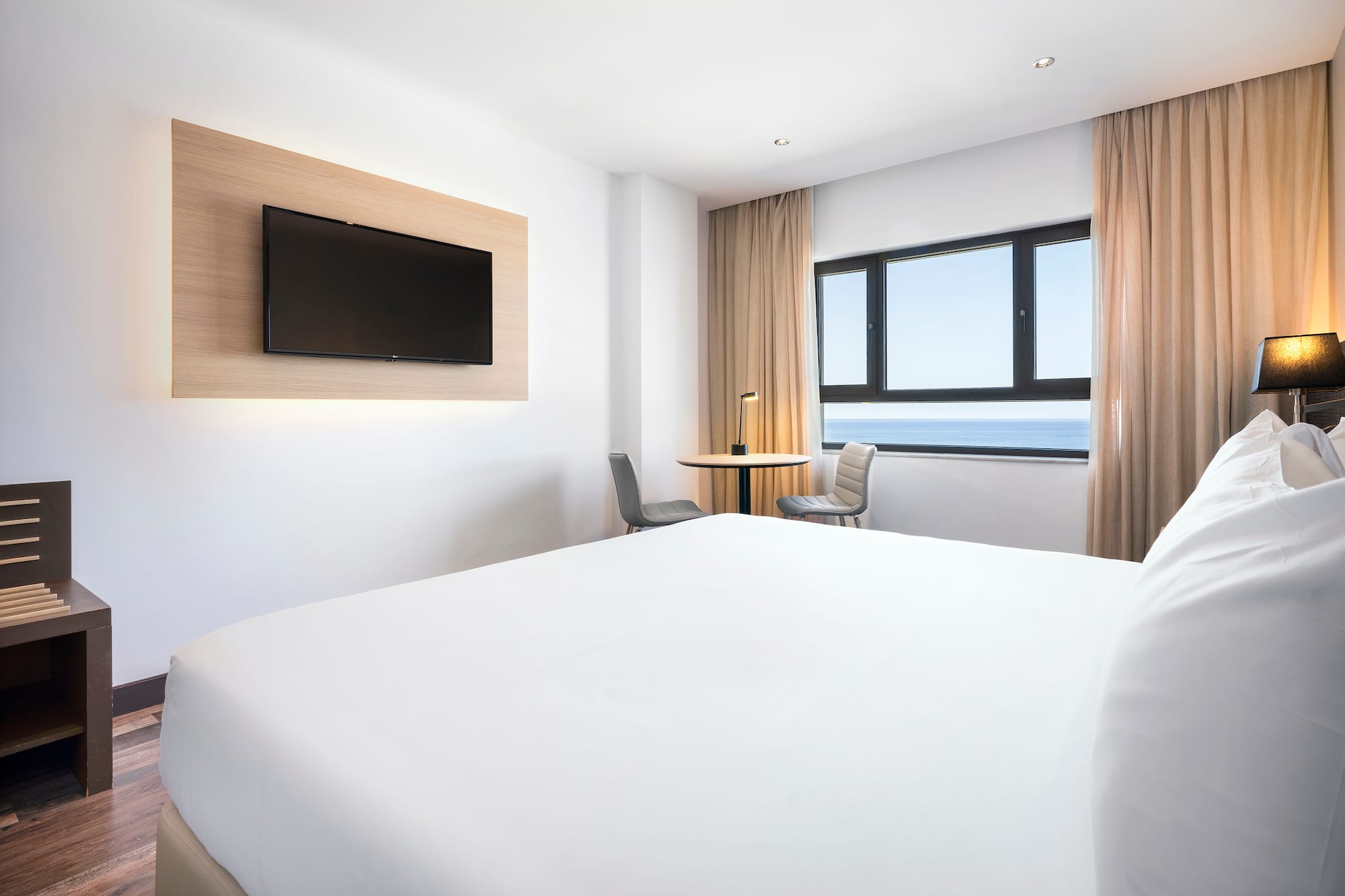 a room with a bed and a television