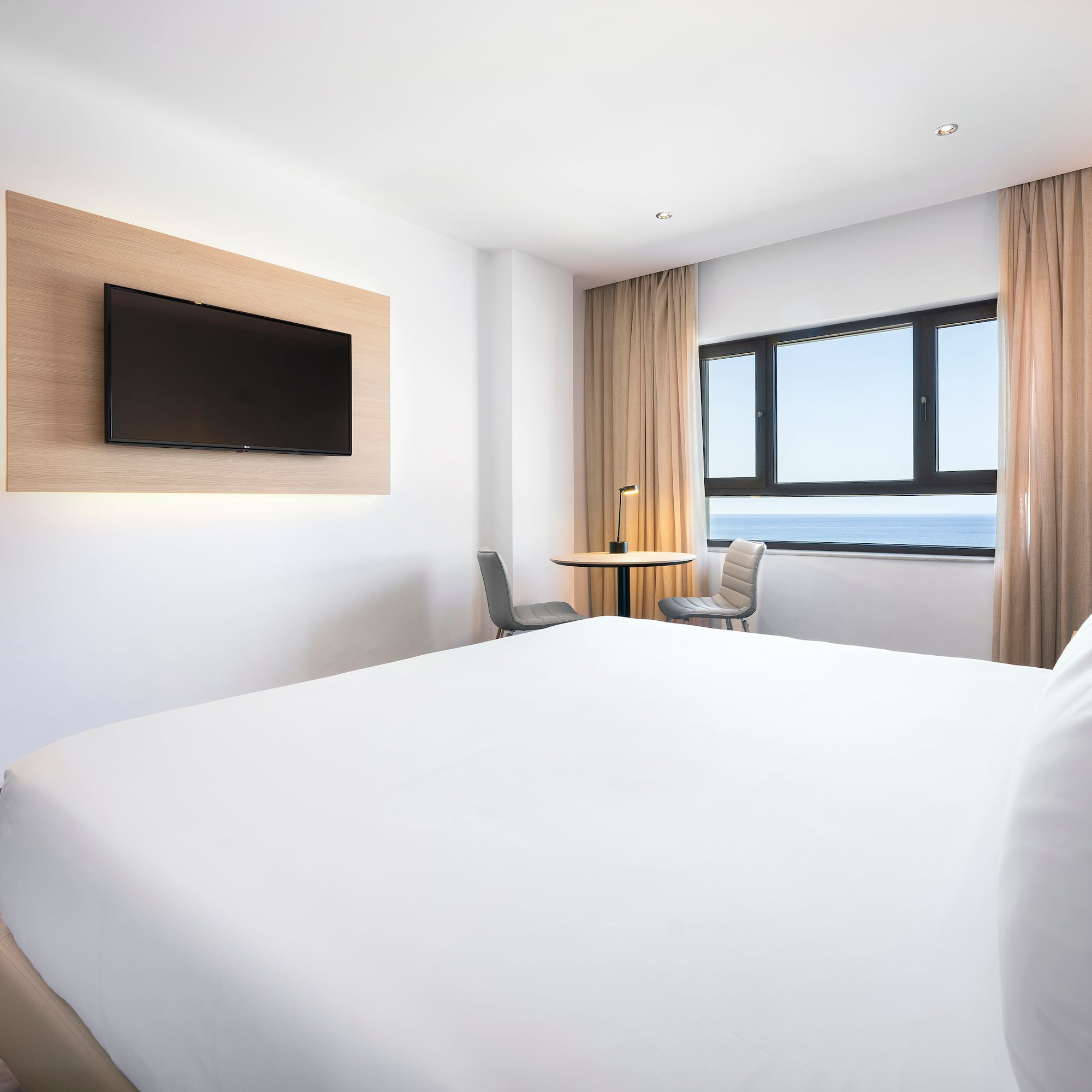 a room with a bed and a television