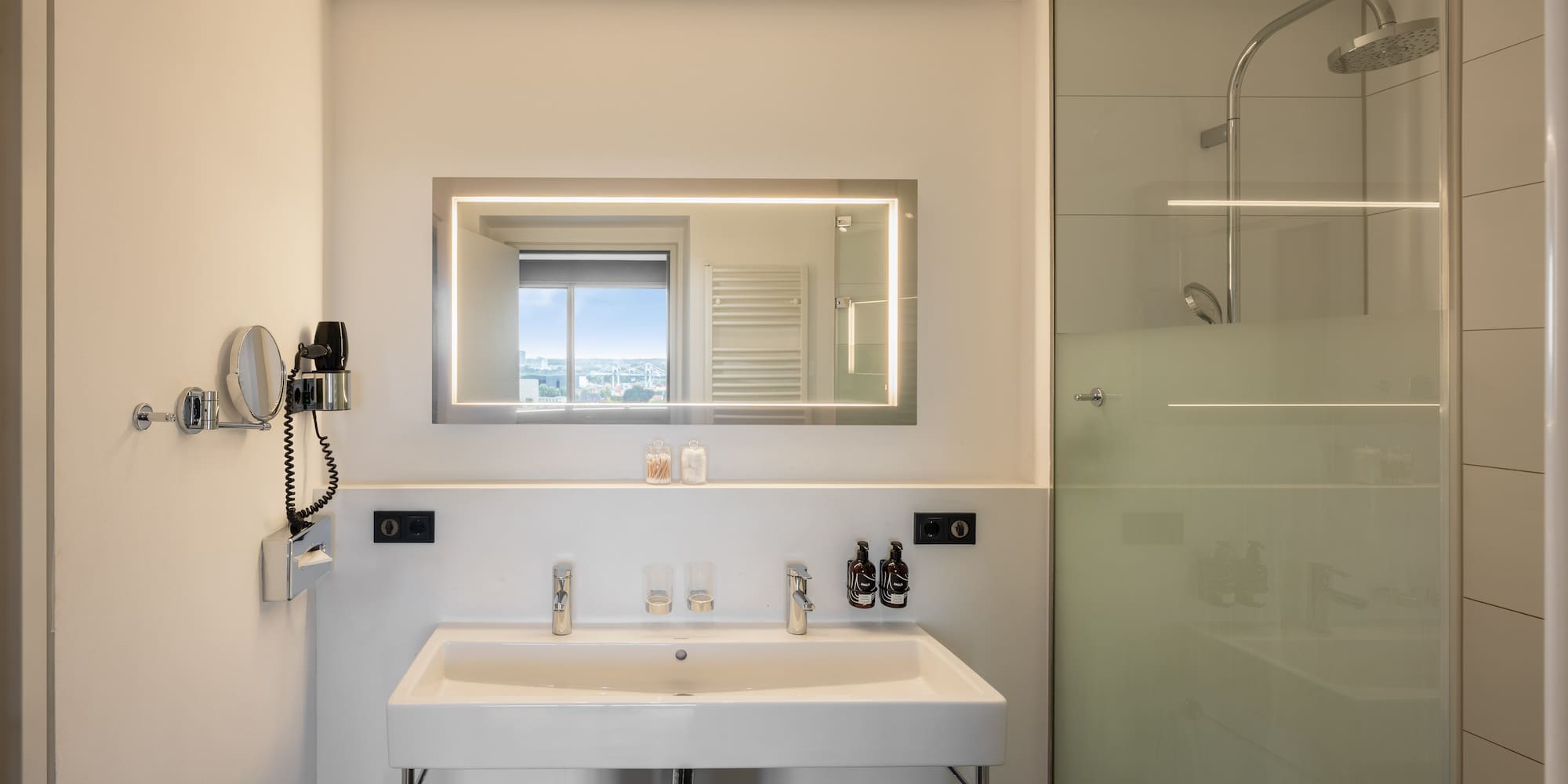 a bathroom with a mirror and a shower