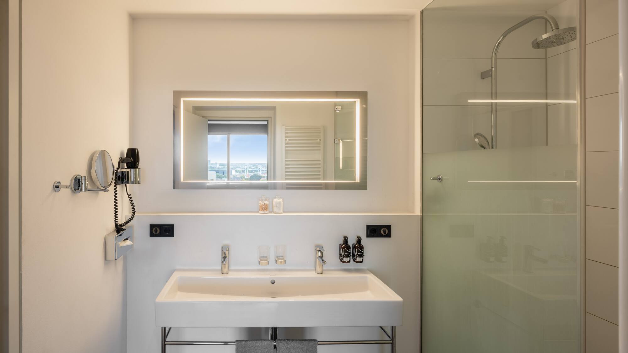 a bathroom with a mirror and a shower