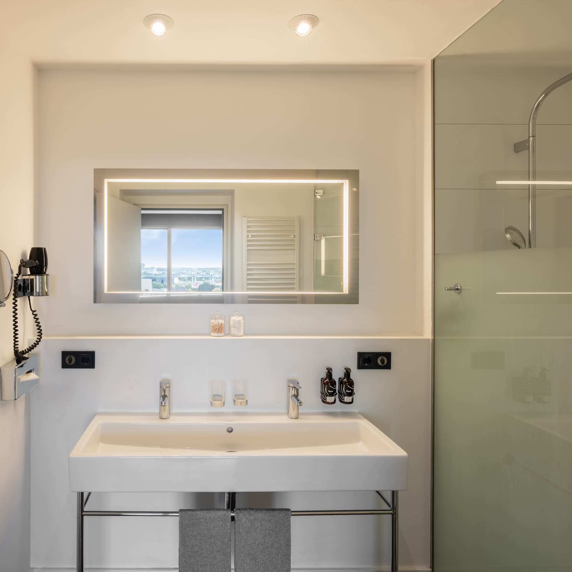 a bathroom with a mirror and a shower