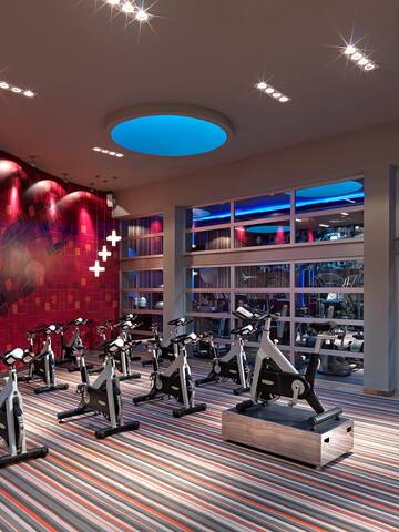 a room with exercise bikes and a large window