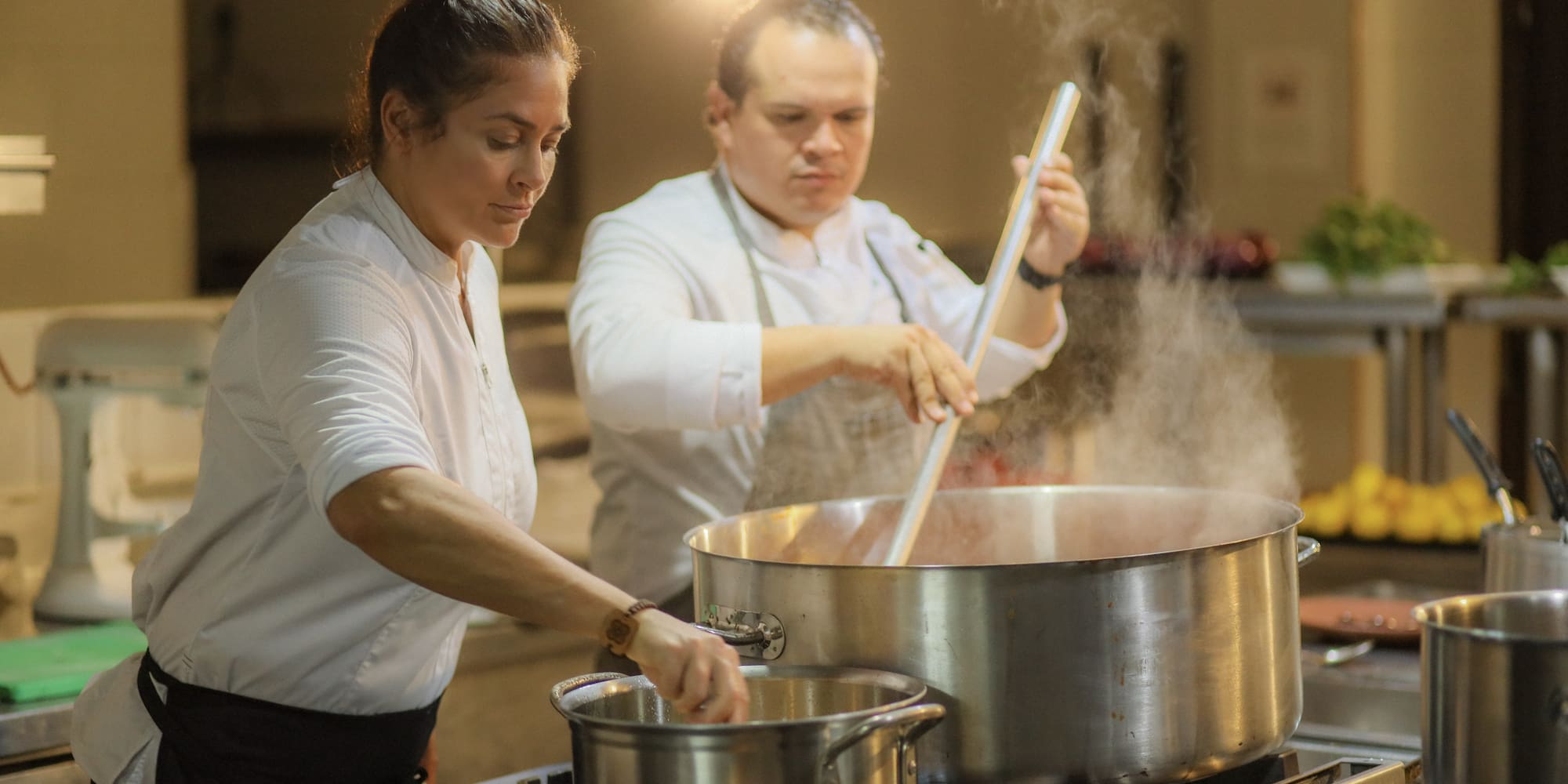 a man and woman cooking in a kitchen