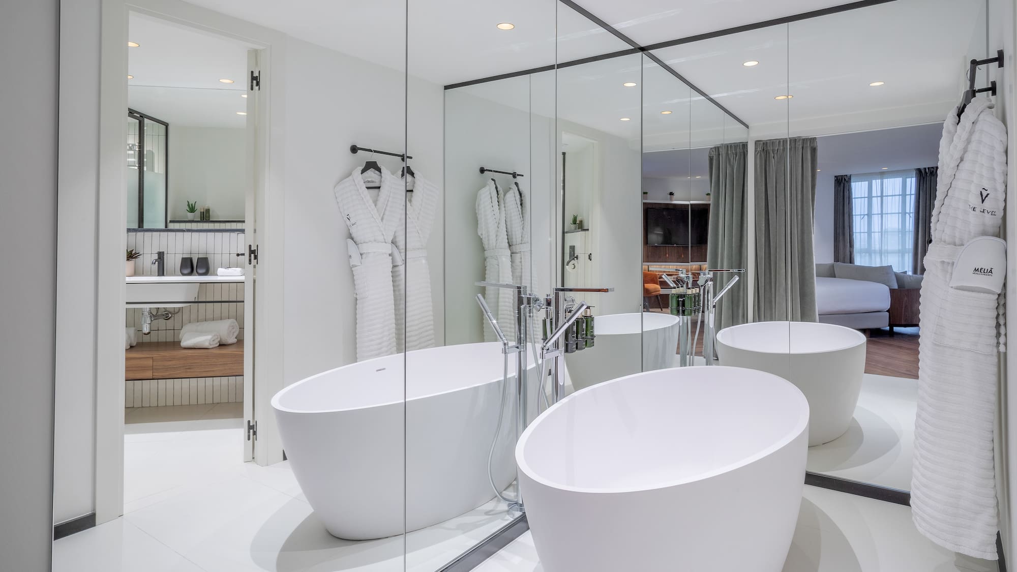 a bathroom with large tubs and mirrors