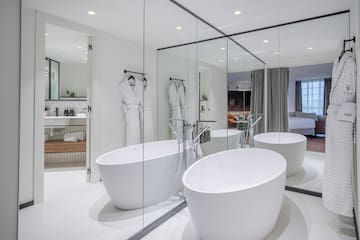 a bathroom with large tubs and mirrors
