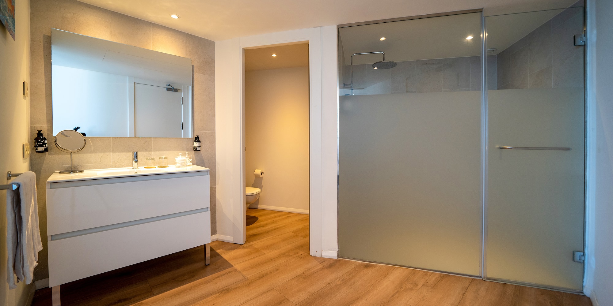 a bathroom with a glass door and a sink