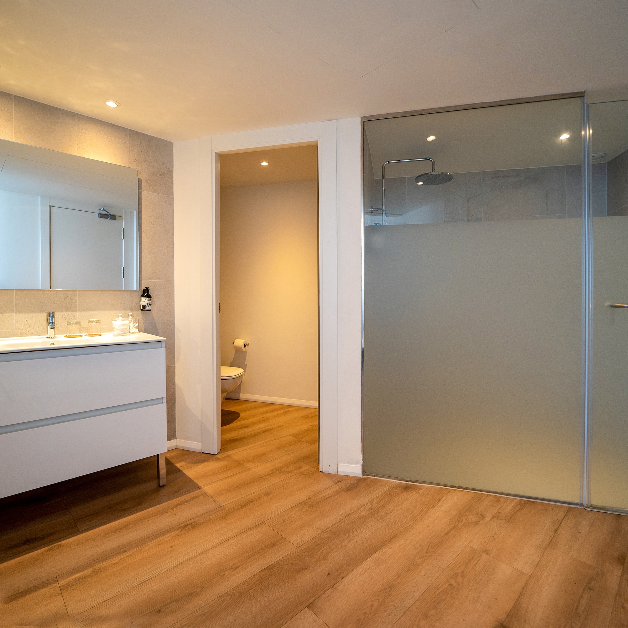 a bathroom with a glass door and a sink