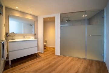 a bathroom with a glass door and a sink