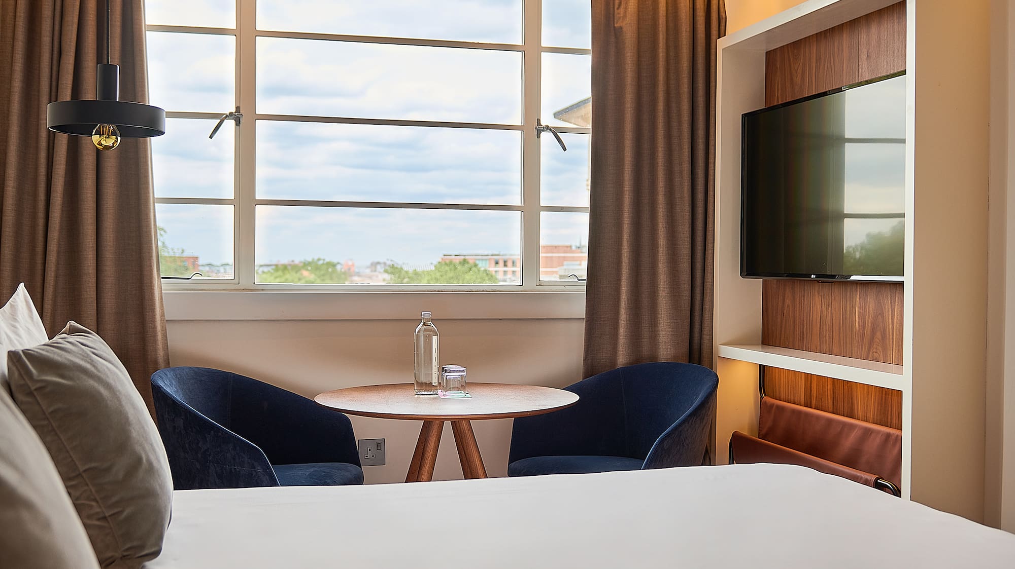 a room with a bed and a tv