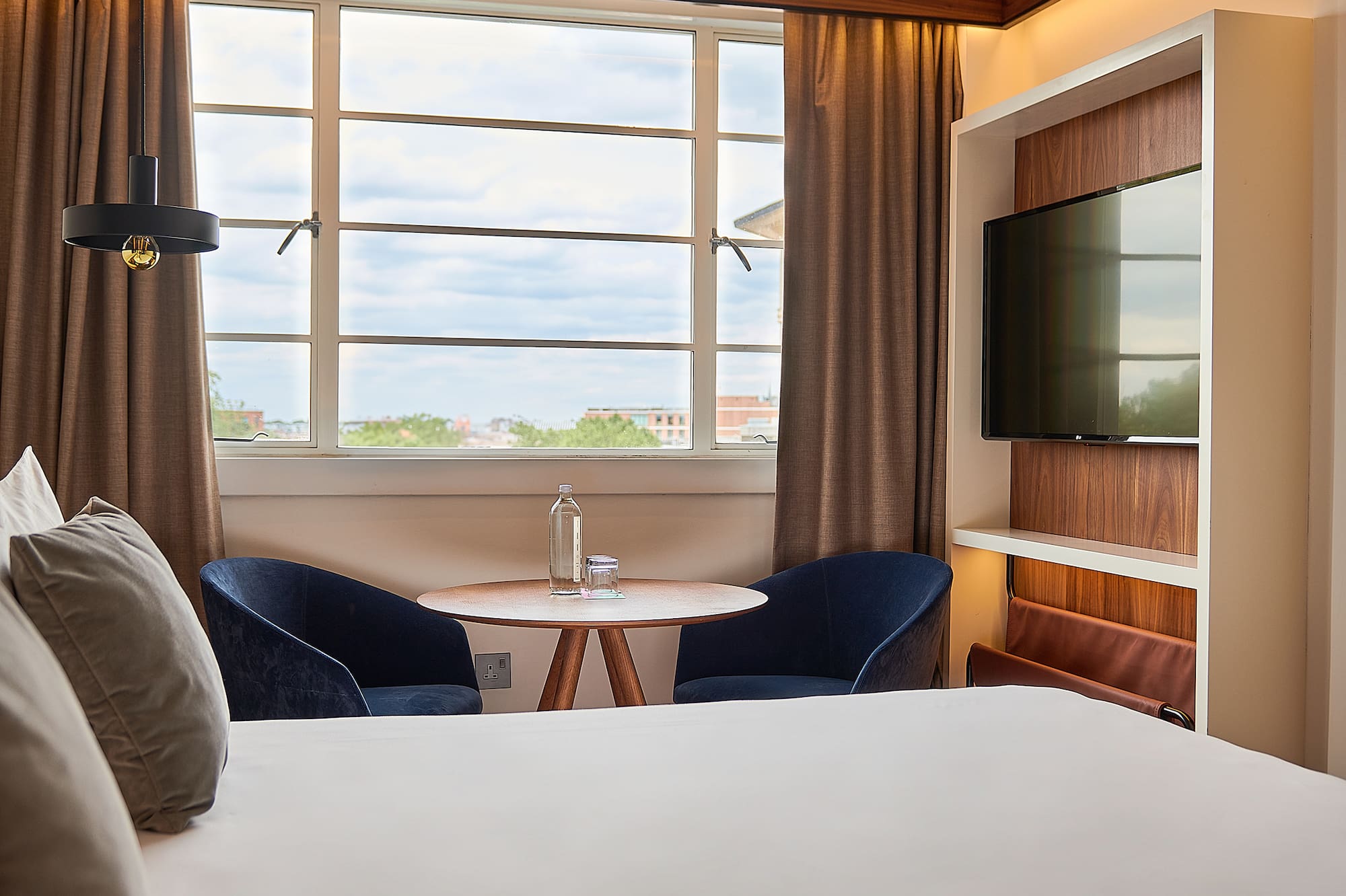 a room with a bed and a tv