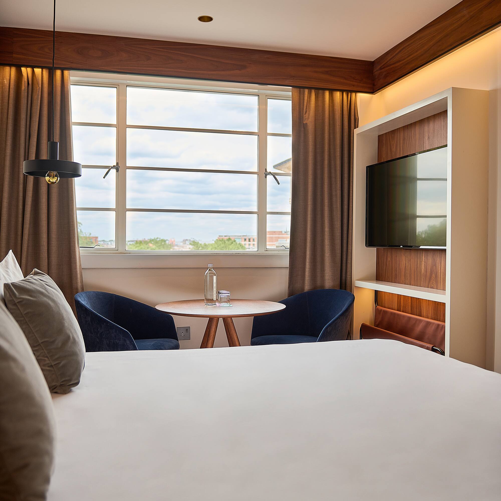 a room with a bed and a tv