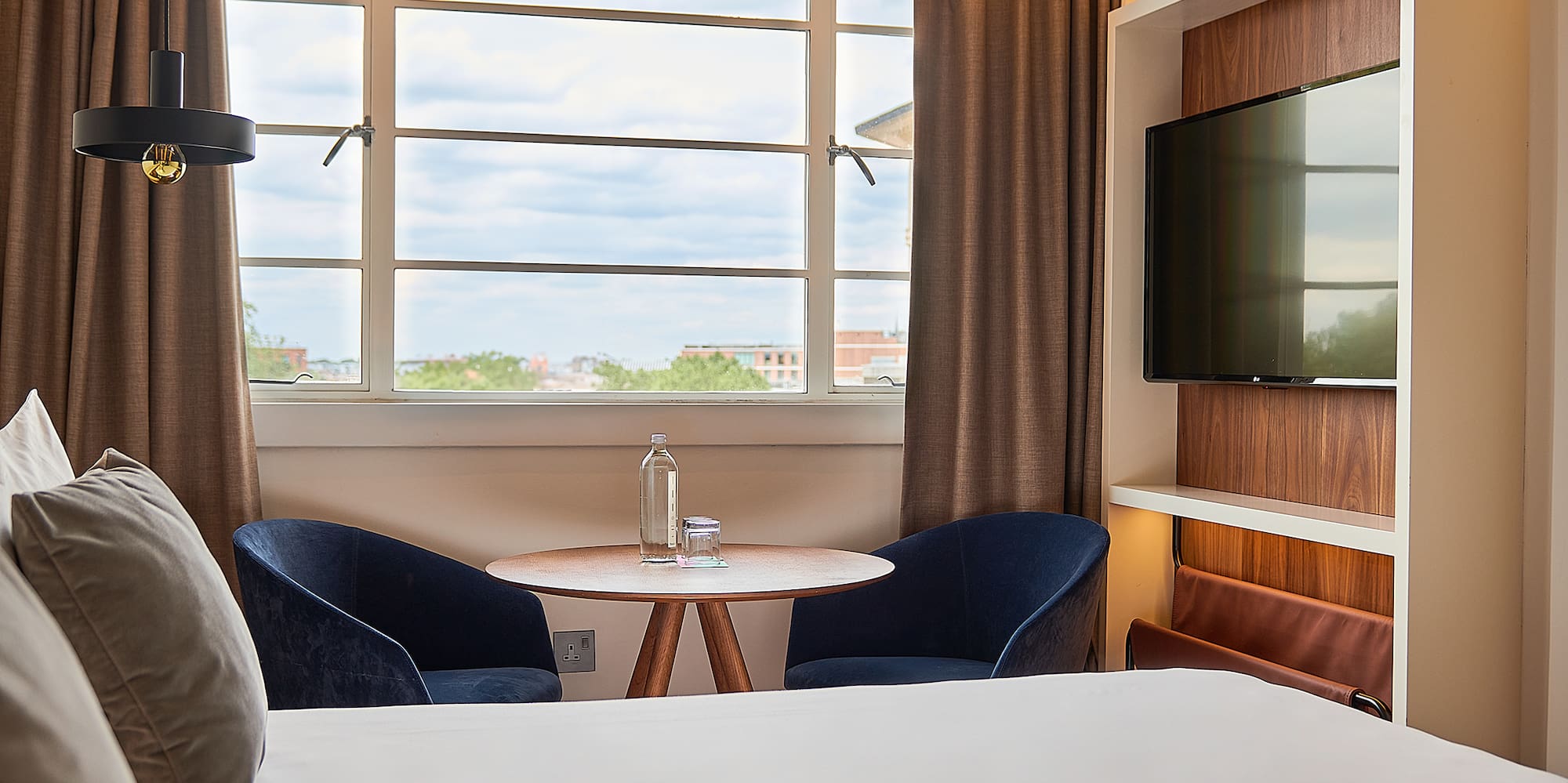 a room with a bed and a tv