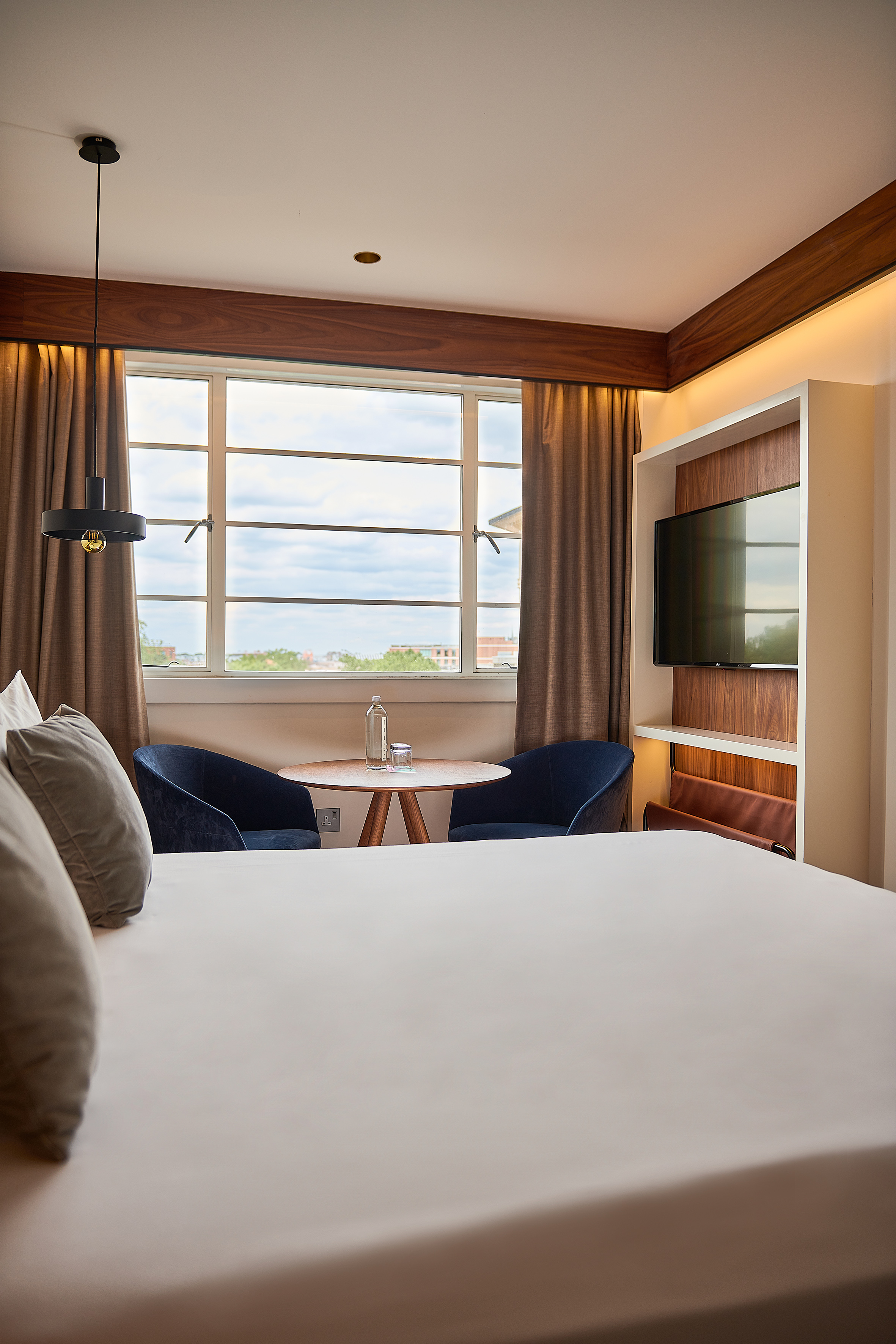 a room with a bed and a tv