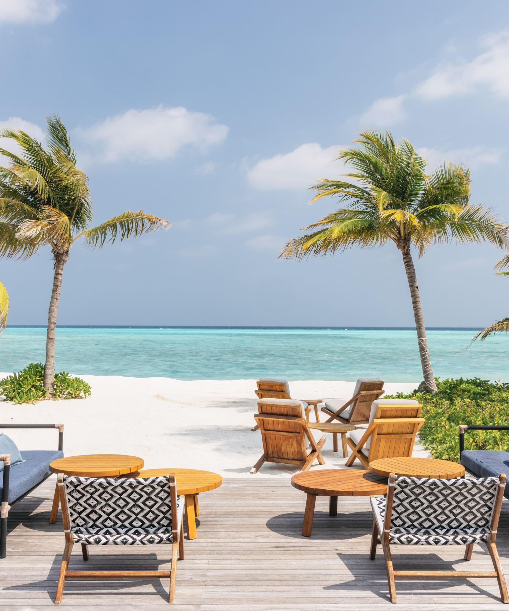 a beach with chairs and tables