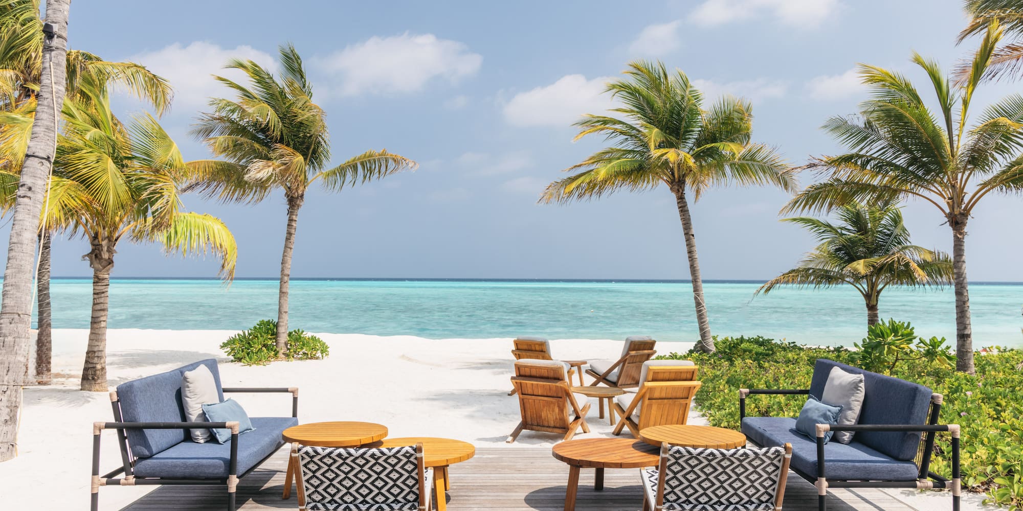 a beach with chairs and tables