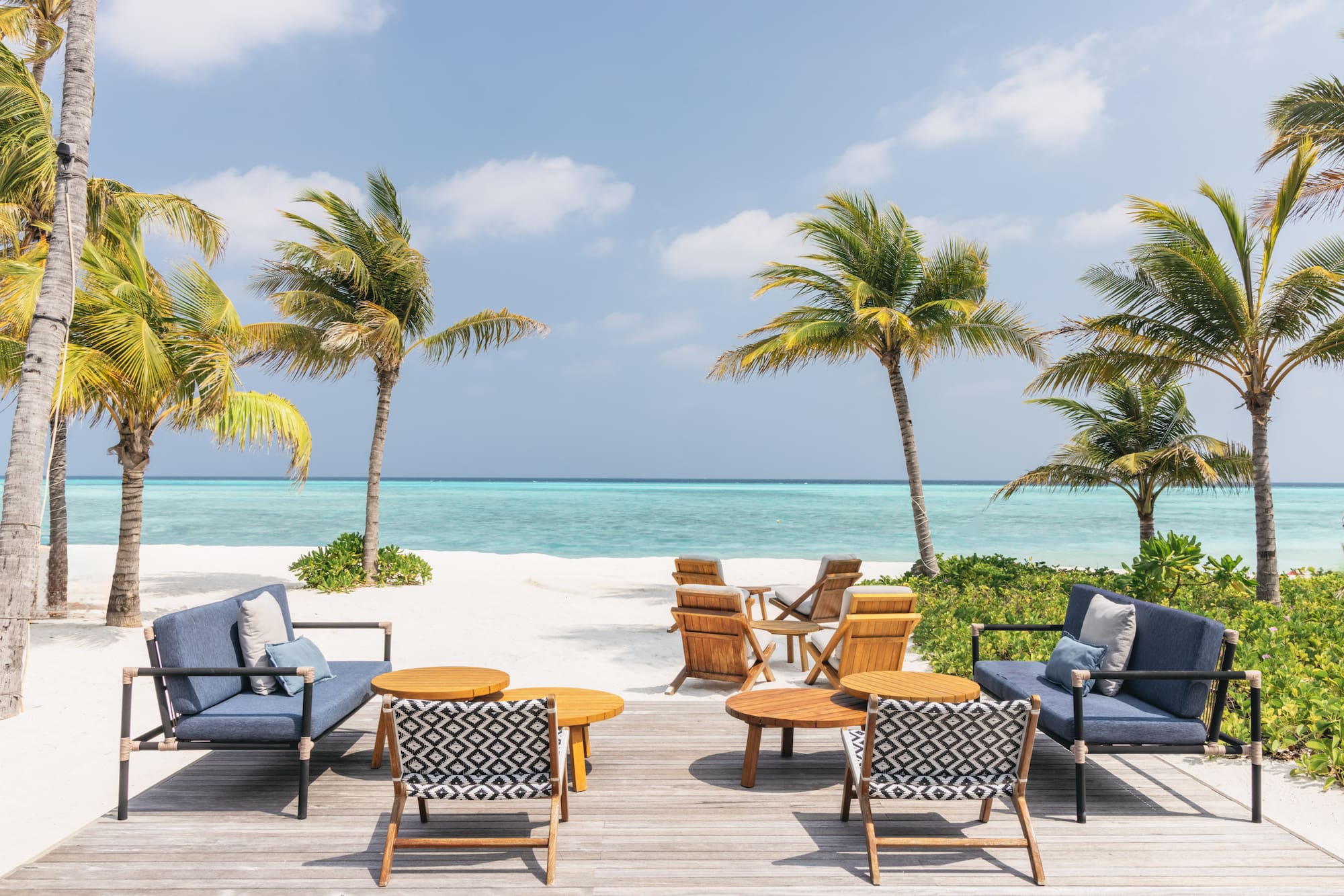 a beach with chairs and tables