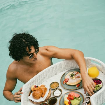 A man enjoying a floating breakfast