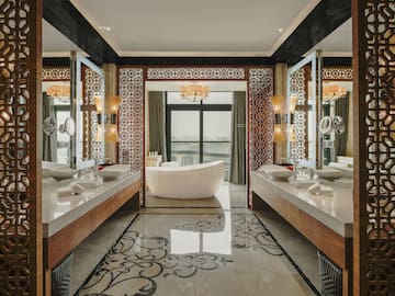 a bathroom with a tub and mirrors
