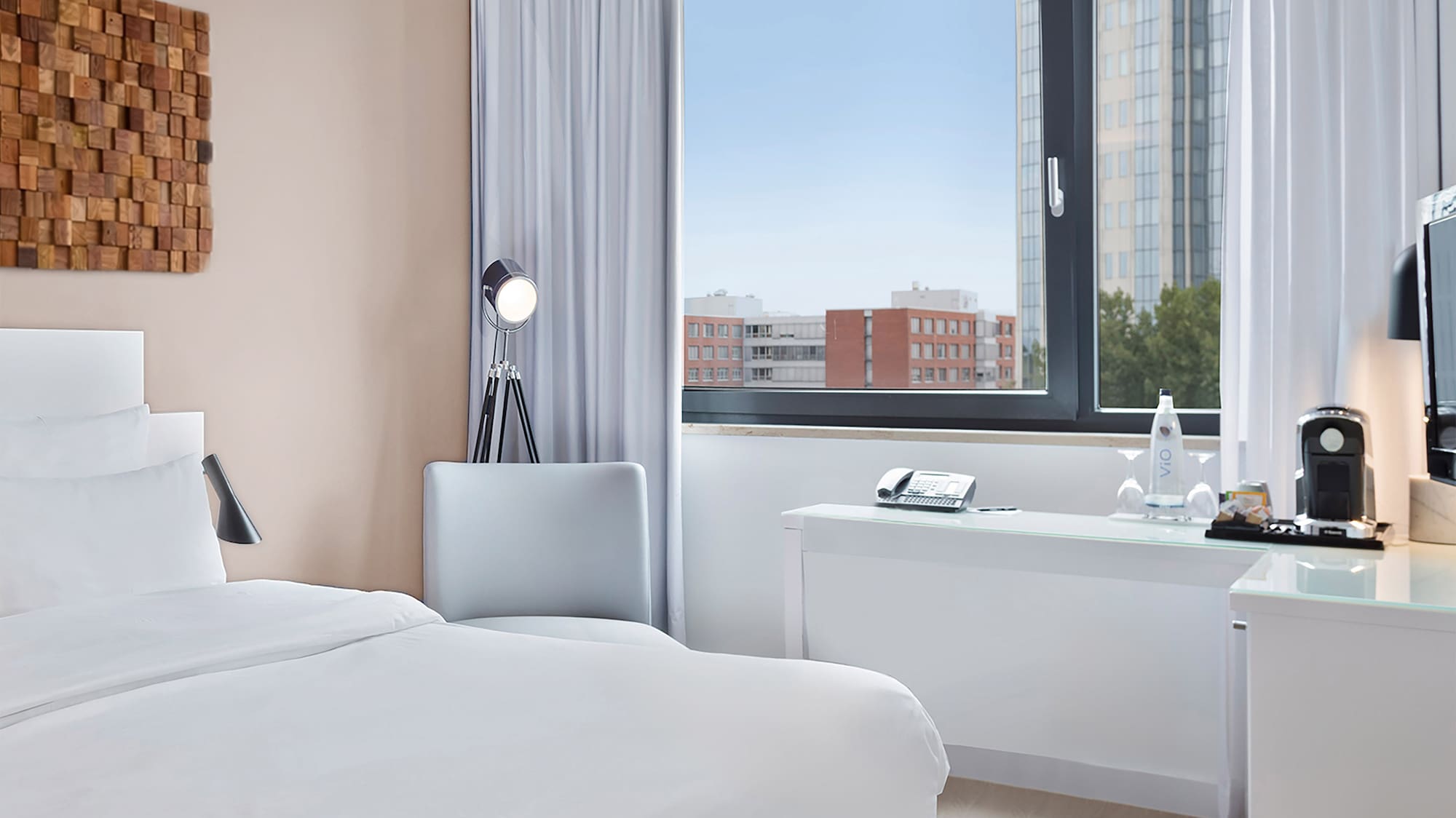 a room with a bed and a desk and a window