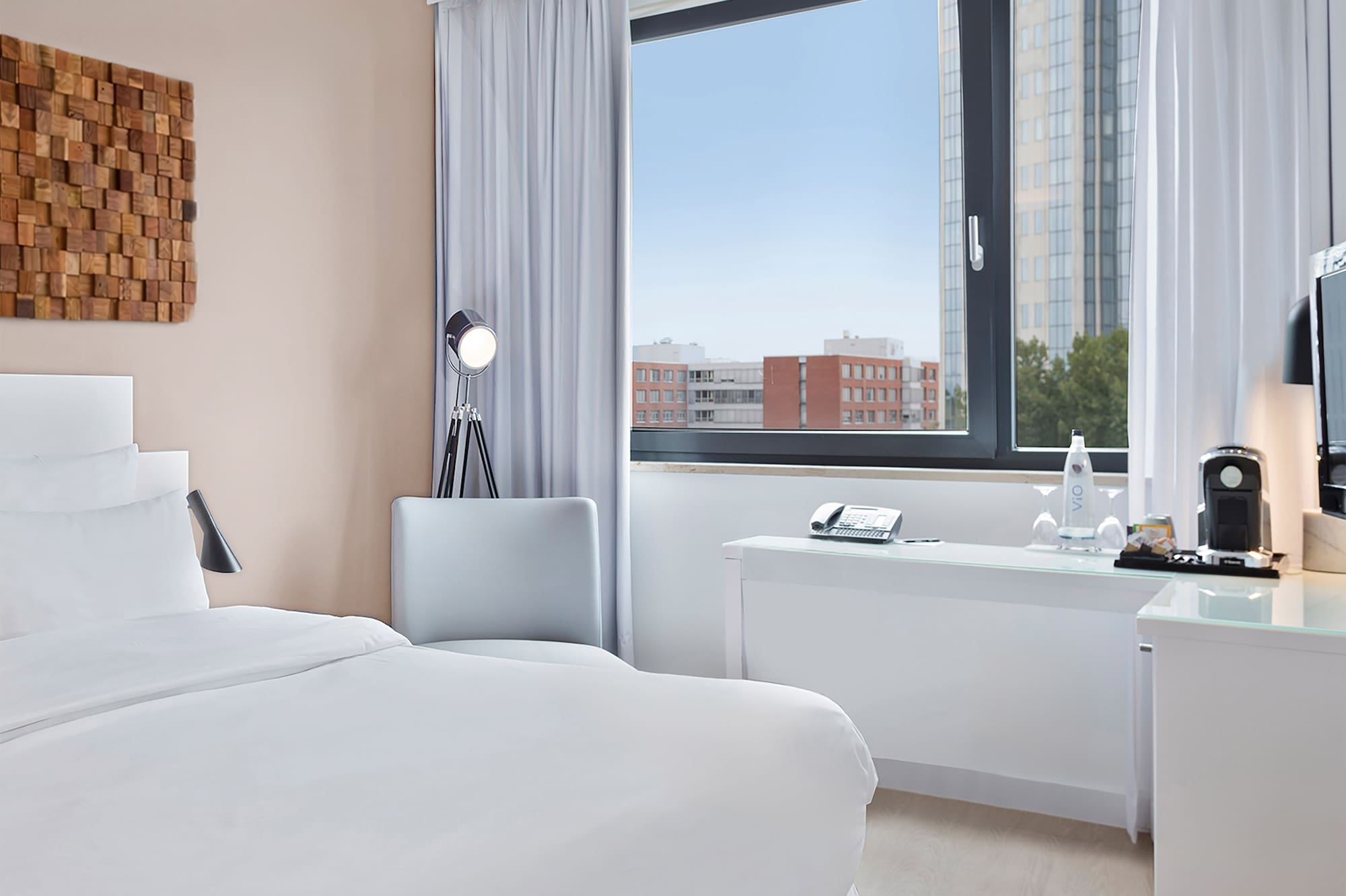 a room with a bed and a desk and a window