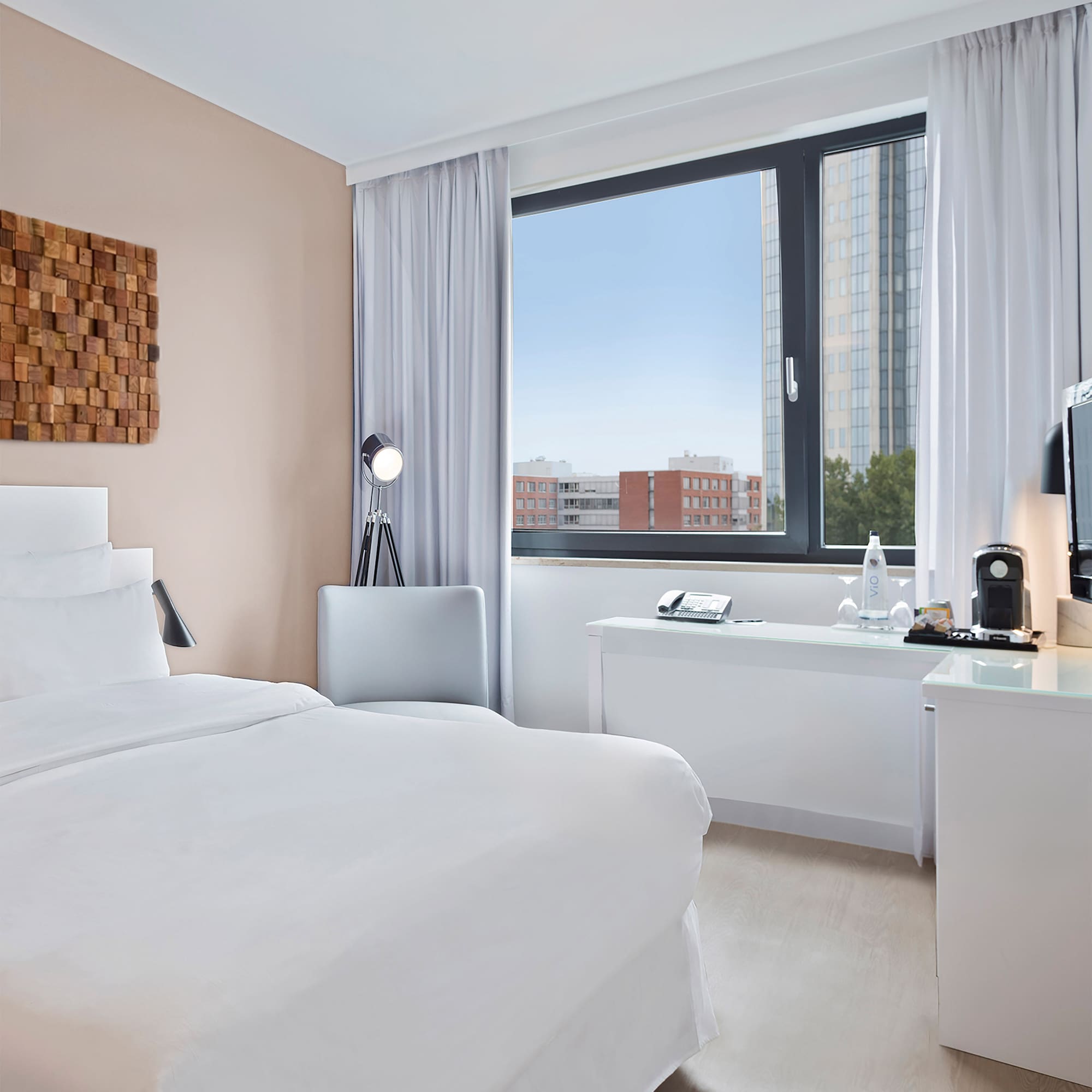 a room with a bed and a desk and a window