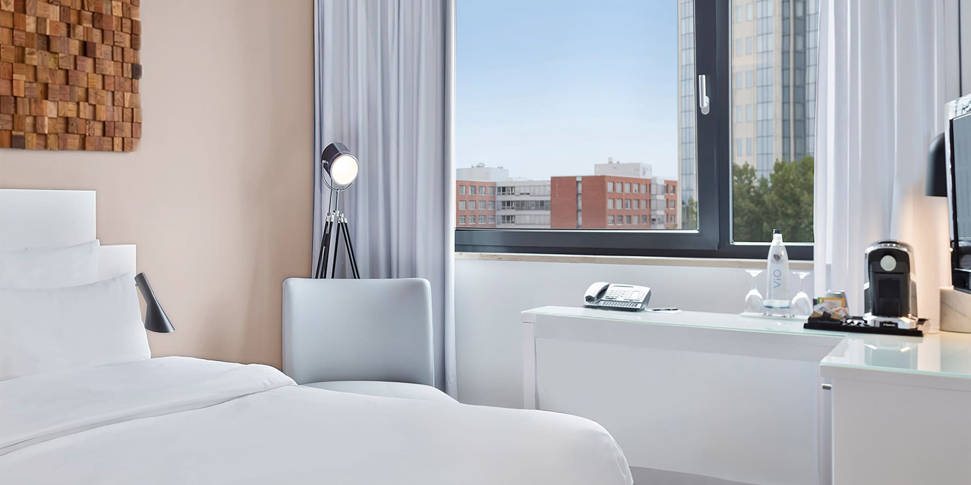 a room with a bed and a desk and a window