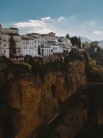 a white buildings on a cliff